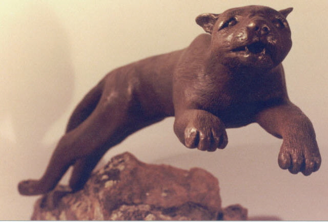 Cougar is bronze mounted on moss rock